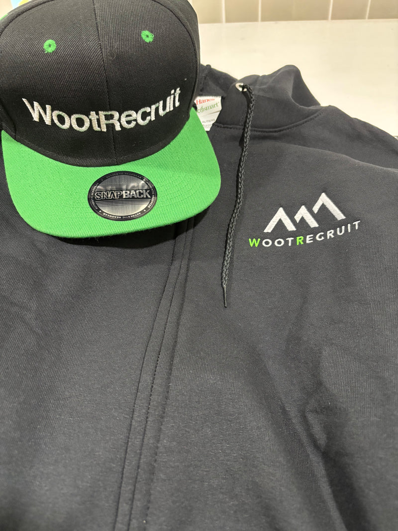 Black jacket with WootRecruit logo, black cap with green brim, and green cap on a white background