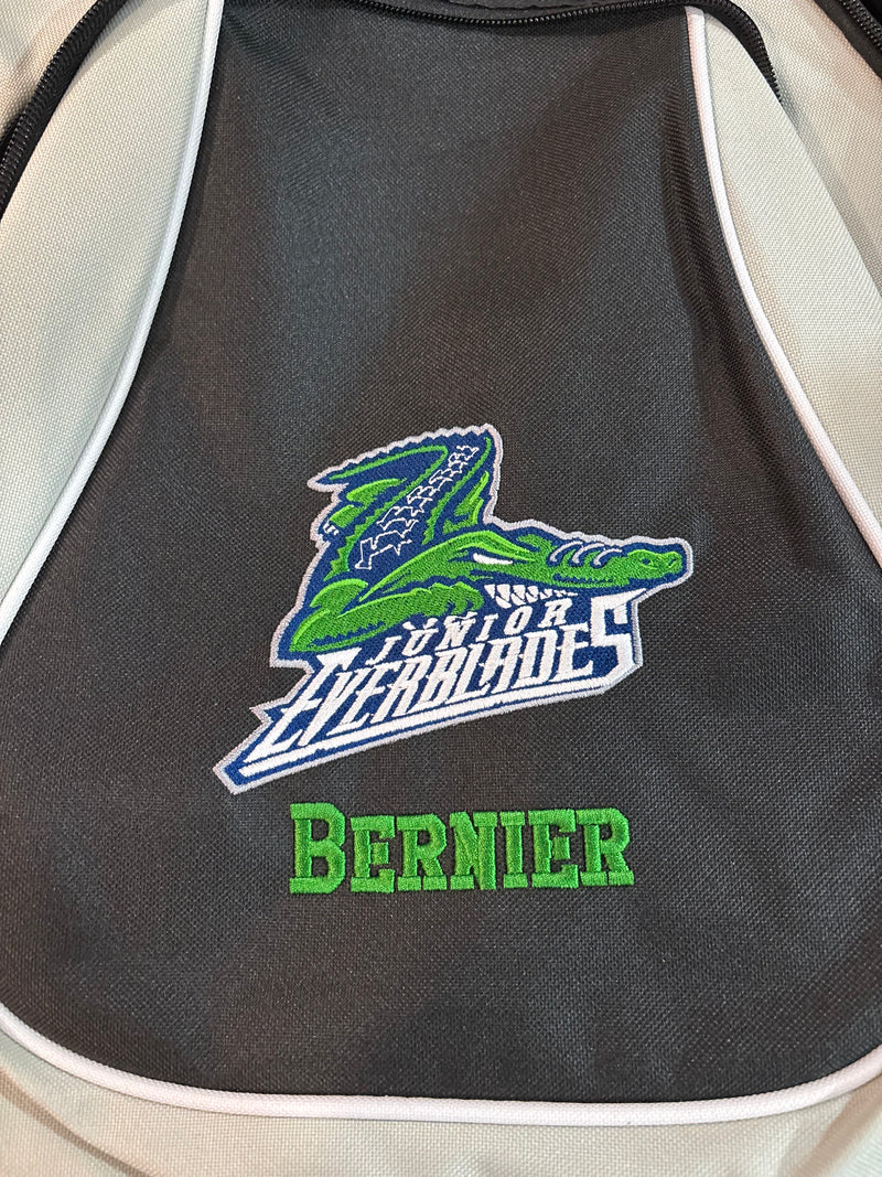 Black bag with green and blue embroidered gator logo and text in green color thread